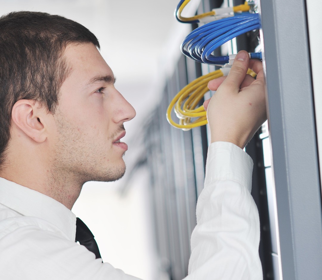 Managed IT Service technician doing network cabling.