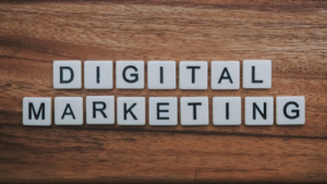 "Digital Marketing" spelled out using tiles on a wooden surface. Online marketing methods help reach your customers.