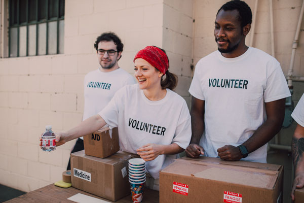 Volunteers handing out water. Canadian charities struggling with digital transformation