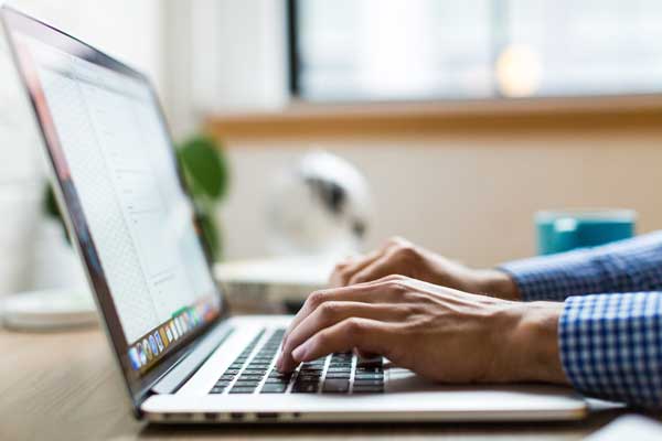 Man on laptop using email